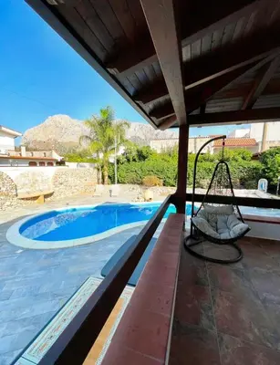 a patio with a swing and a swimming pool at Villa Seaside in Cinisi