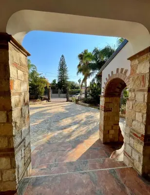 a building with a bench next to a stone wall at Villa Seaside in Cinisi