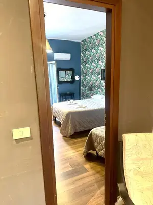 a view of a bedroom with two beds and a mirror at Porta di Castro's Home in Palermo