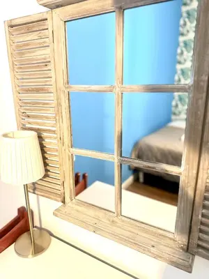 a room with a window with a lamp and a bed at Porta di Castro's Home in Palermo