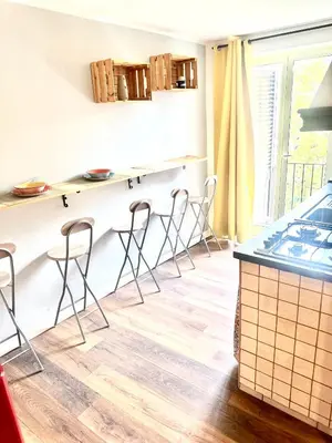 a kitchen with bar stools and a counter top at Porta di Castro's Home in Palermo