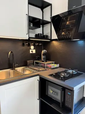 a kitchen with a sink and a stove top oven at Oasi urbana Palermo in Palermo