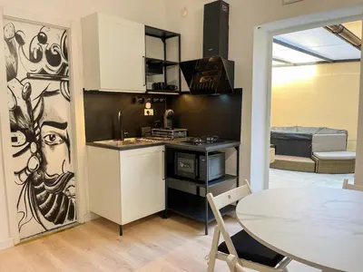 a kitchen with a table and a dining room at Oasi urbana Palermo in Palermo