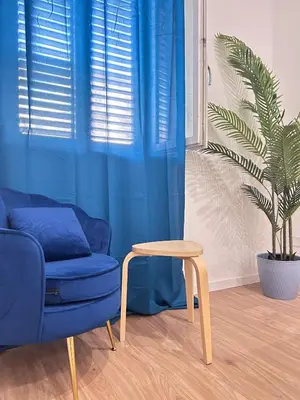 a living room with a blue couch and a table at Dimora dell'Olivella 2 in Palermo