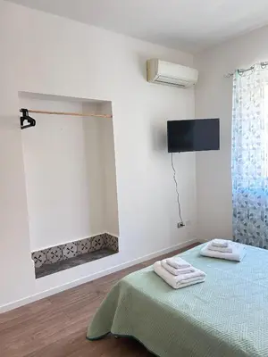 a bedroom with a bed with two towels on it at Dimora dell'Olivella 2 in Palermo