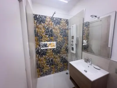 a white room with a bed and a tv at Daimana holiday apartament in Palermo