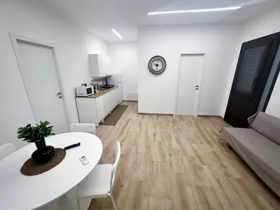 a small kitchen with a microwave and a sink at Daimana holiday apartament in Palermo