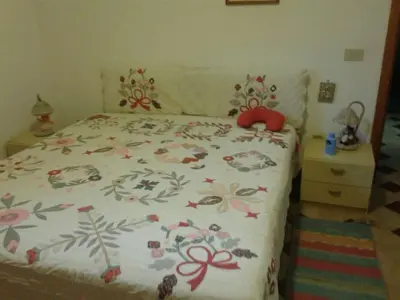 a bedroom with a bed with a red stuffed animal on it at Apartment Villa Gina in Trappeto by Interhome in Trappeto