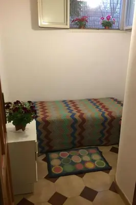 a bed in a room with a rug and a window at Apartment Villa Gina in Trappeto by Interhome in Trappeto