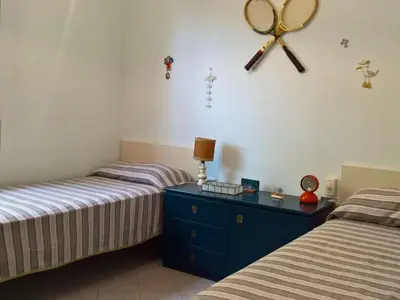 a bedroom with two beds and a blue dresser at Holiday Home Villa Aliotis 200m vom Meer entfernt by Interhome in Alcamo Marina