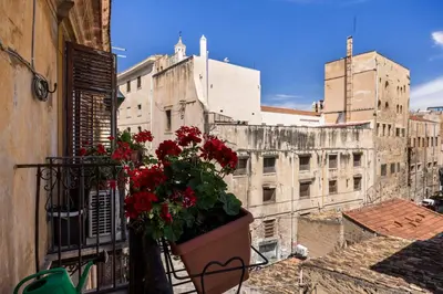 a living room with white walls and a door at Casa Bellini - Centro Storico in Palermo
