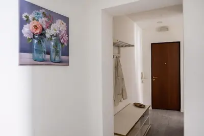a bathroom with a painting of flowers in blue vases at Casa Bellini - Centro Storico in Palermo