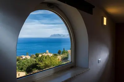 an arched window with a view of the ocean at APT NINO in Villa Rosaria Vista Mare Zingaro in Scopello