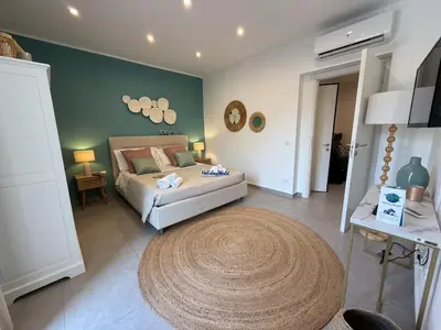 a bedroom with a bed and a large rug at palermo house in Palermo