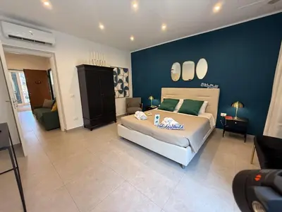 a bedroom with a bed and a blue wall at palermo house in Palermo
