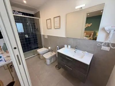 a bathroom with a sink and a toilet and a mirror at palermo house in Palermo