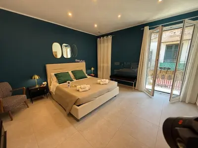 a bedroom with a large bed and a large window at palermo house in Palermo