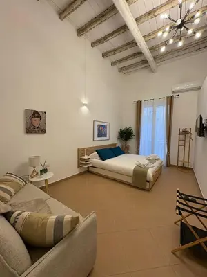 a large room with two beds and a couch at La Dimora dei Pupi - Centro Storico in Palermo