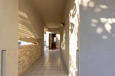 a hallway of a house with shadows on the wall at Visitsicilia Sabbia Dorata in Alcamo Marina