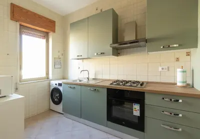 a kitchen with a sink and a stove top oven at Visitsicilia Saramia in Balestrate
