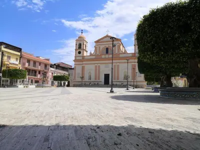 a large building with a clock tower in a courtyard at Visitsicilia Saramia in Balestrate