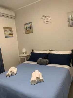 a bedroom with a blue bed with towels on it at Cattedrale stay in Palermo