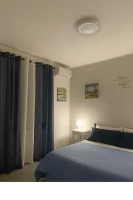 a bedroom with a bed with blue drapes at Cattedrale stay in Palermo