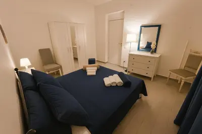 a bedroom with a blue bed with two towels at Cattedrale stay in Palermo