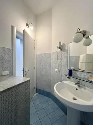 a bathroom with a sink and a mirror at Palermo Central BB in Palermo