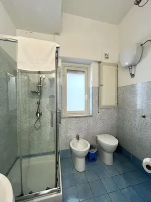 a bathroom with a shower and a toilet and a sink at Palermo Central BB in Palermo