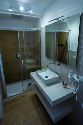 a room with a bathroom with a tub and a table at Aromatika Suite in Palermo