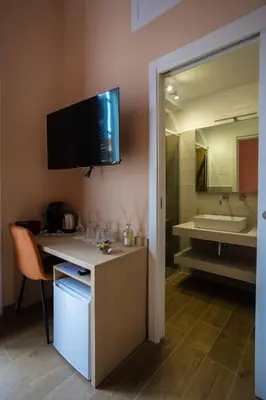 a bathroom with two sinks and a large mirror at Aromatika Suite in Palermo