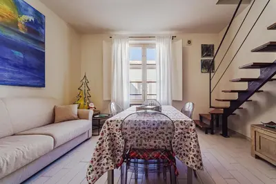 a kitchen with a table and a couch in a room at Hybrid Icon Rooms Gallery City Center in Palermo