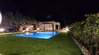 a swimming pool in the yard of a house at night at Villa du Cori in Alcamo