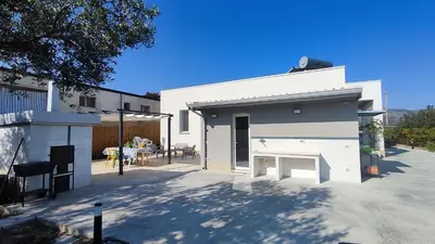 a white building with a fireplace in a parking lot at Villa du Cori in Alcamo