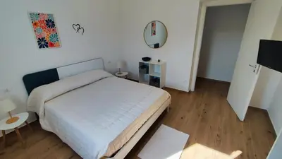 a bedroom with a bed and a table and a mirror at Villa du Cori in Alcamo