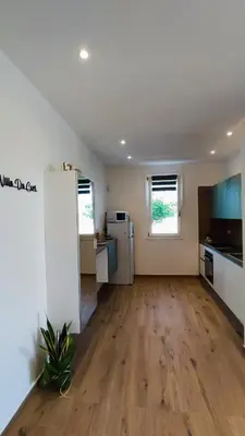 an empty room with a kitchen and a living room at Villa du Cori in Alcamo