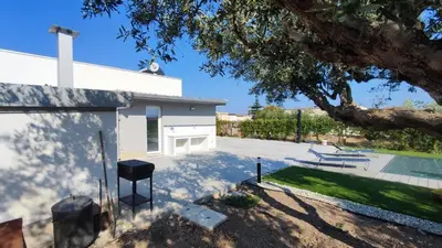 a backyard with a pool and a house at Villa du Cori in Alcamo