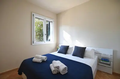 a bedroom with two towels on a bed at iFlat Punta Catalana in Terrasini