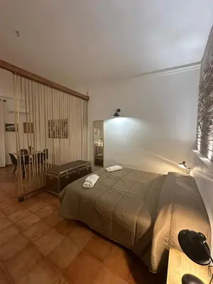 a room with two beds and a flat screen tv at Loft Materassai in Palermo