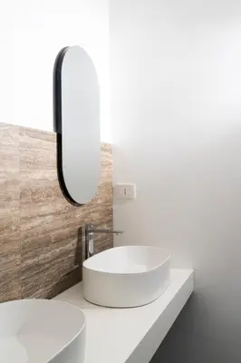 a bathroom with a white sink and a mirror at Skyline Boutique Hotel in Palermo