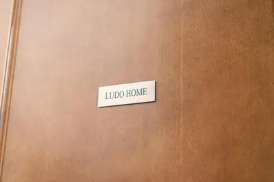 a wooden door with a sign that reads lipid home at Ludohome in Palermo