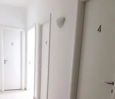 a white room with two doors and a window at Aurea Suites in Palermo