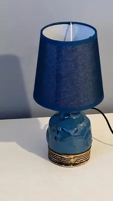 a blue lamp sitting on top of a table at Aurea Suites in Palermo