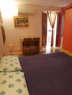 a bedroom with a bed and a table and chairs at Tomicla in Monreale