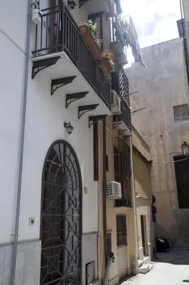 an alley with a building with a door and balconies at Zagarellai apartment alla Kalsa Fast wi-fi in Palermo