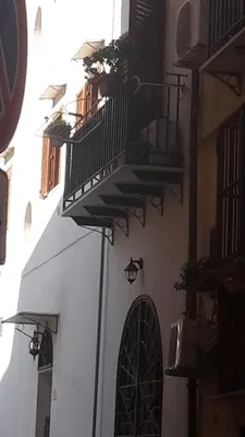a white building with a balcony and a window at Zagarellai apartment alla Kalsa Fast wi-fi in Palermo