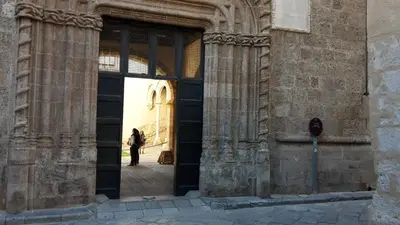a person standing in the doorway of a building at Zagarellai apartment alla Kalsa Fast wi-fi in Palermo