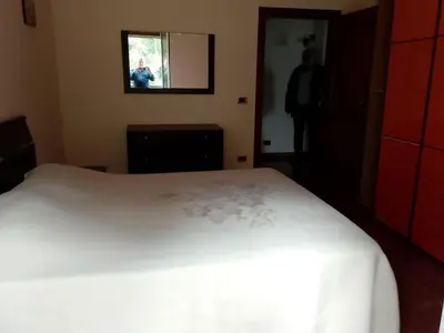 a bedroom with a white bed and a window at Altofonte Vista in Altofonte