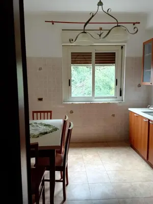 a kitchen with a table and chairs and a window at Altofonte Vista in Altofonte